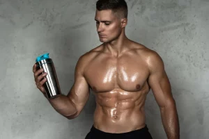 Shirtless muscular man holding a tumbler